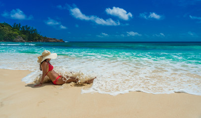 Fototapeta na wymiar Happy girl at Beautiful beach on island Mahé in Seychelles - Anse Intendance 