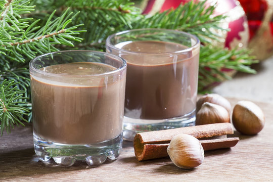 Hot chocolate with cinnamon and nuts, decorated with fir branche