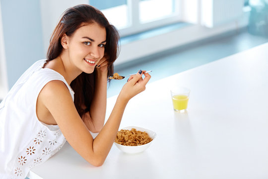 Wellness concept. Woman having breakfast and smiling. Healthy ea