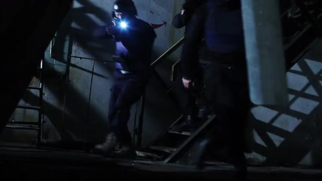 Special Forces Team Moving Down Staircase in Abandoned Building