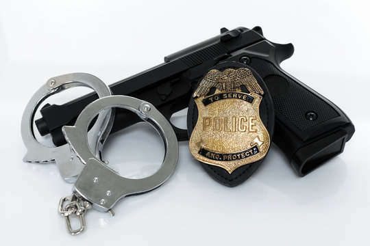 Police badge, gun and handcuffs
