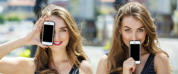 Young blonde women covers her face screen smartphone