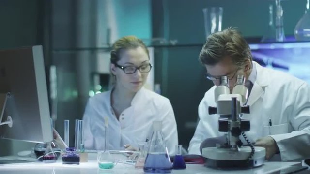 Professor and Student Girl are Doing Chemical Researches in Laboratory