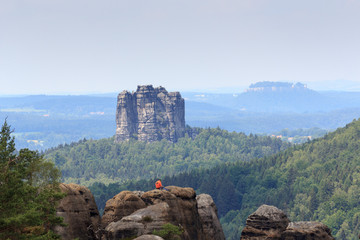 Rock climber in front of the Falkenstein in Saxon Switzerland