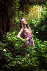 Portrait of beautiful young woman posing at garden