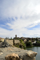 Fototapeta na wymiar Fortified village and river, vertical, Buitrago del Lozoya