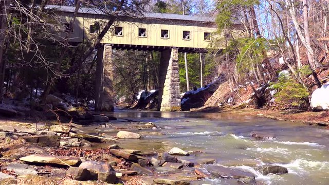 A beautiful covered bridge over a river in Ohio.