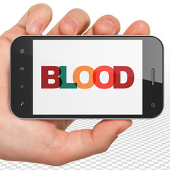 Health concept: Hand Holding Smartphone with Blood on  display