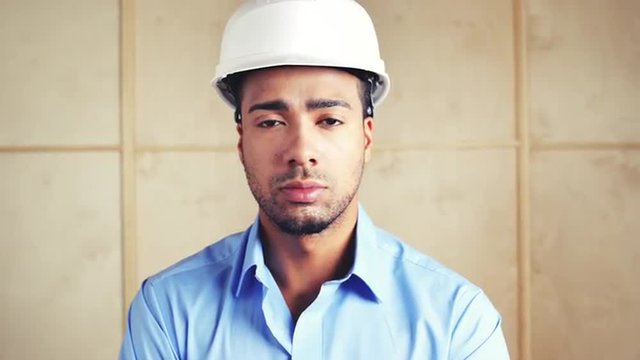 Serious engineer portrait on building site