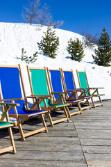 Sun beds in the snow mountain