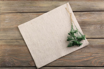 Beautiful dry flowers on napkin on wooden background