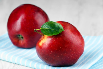 Ripe red apples on table close up