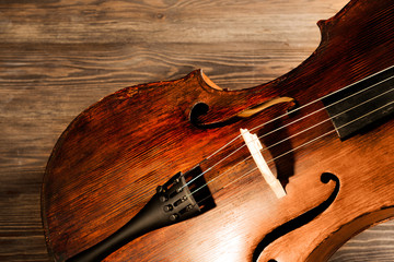 Vintage cello on wooden background