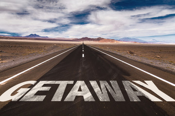 Getaway written on desert road