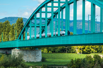 New modern fast train crossing green Railway bridge over Sava river in Zagreb, Croatia
