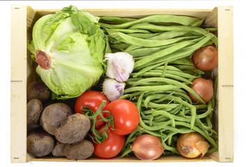 seasonal vegetables in a crate isolated on a white background