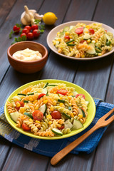Vegetarian pasta salad made of tricolor fusilli, sweet corn, cucumber, cherry tomato, photographed...