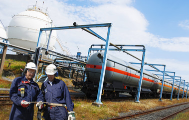 oil and gas workers with train loaded with crude oil and fuel