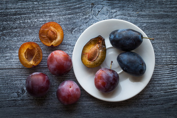 Fresh plums on a rustic wooden table