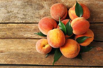 Ripe peaches on wooden background