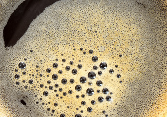 Tasty Coffee in cup on background