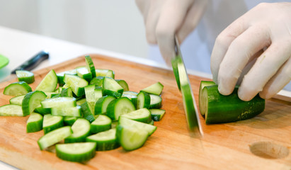 Chef cuts the cucumber salad