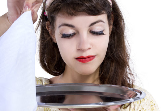 Retro Style Female Waitress Unveiling A Surprise Hidden In A Tray And Napkin