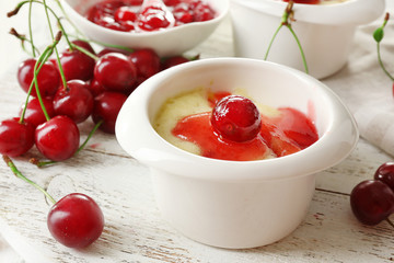 Tasty pudding with cherries on table close up