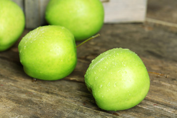 Ripe green apples on wooden table close up