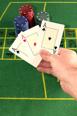 Hand holding several poker cards