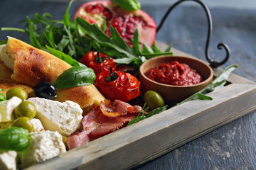 Ingredients of Mediterranean cuisine, on wooden tray, on wooden background