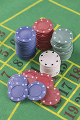 Poker chips on green carpet