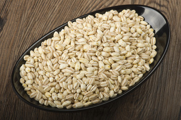 Spoon of Pearl barley close up on a table