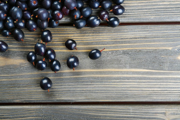 Heap of wild black currant on wooden table close up