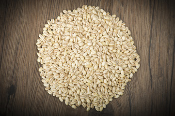Spoon of Pearl barley close up on a table