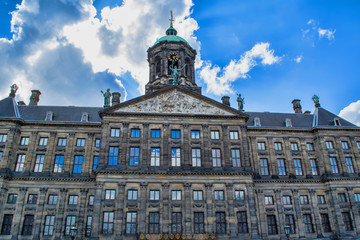Fototapeta na wymiar The Royal Palace of Amsterdam on a sunny day. The former Amsterdam town hall, now one of the three palaces in the Netherlands, which are at the disposal of the monarch.