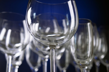 Empty wine glasses on blue background