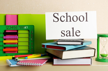 School supplies for sale, on light wall background