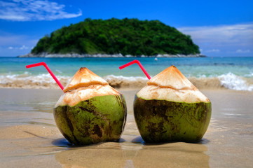 Coconut cocktail on the white Sands of the Paradise coast of Phuket island in Thailand. - obrazy, fototapety, plakaty