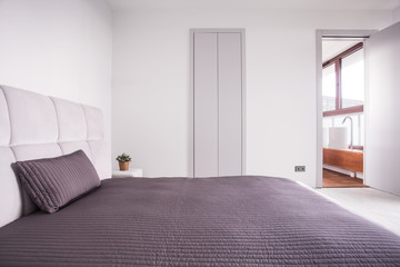 Beige bedclothes in bright bedroom