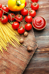 Pasta spaghetti with tomatoes, cheese and basil on rustic wooden  background