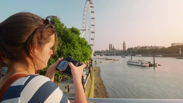Tourist photographer filming London Eye Big Ben Sightseeings at sunset