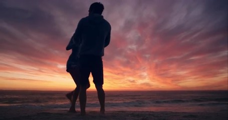 Happy couple dancing on beach enjoying honeymoon in nature at sunset silhouetted wide shot RED DRAGON