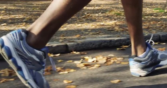 Close up feet running Runner man in park exercising outdoors