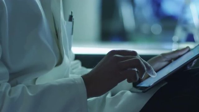 Middle Aged Male Scientist using Tablet in Laboratory