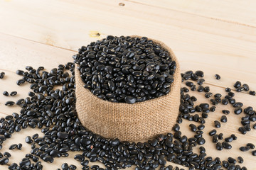 black beans on wood background