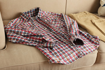 Male clothing on sofa in room