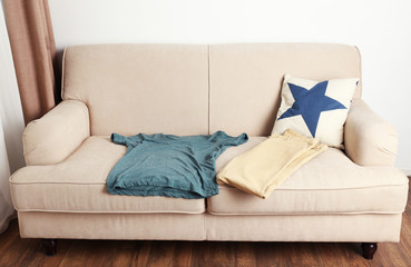 Male clothing on sofa in room