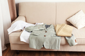 Fototapeta na wymiar Male clothing on sofa in room