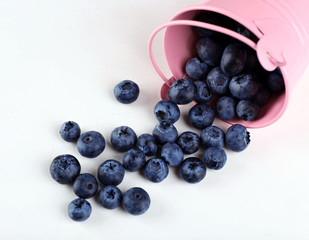 Tasty ripe blueberries in bucket on table close up